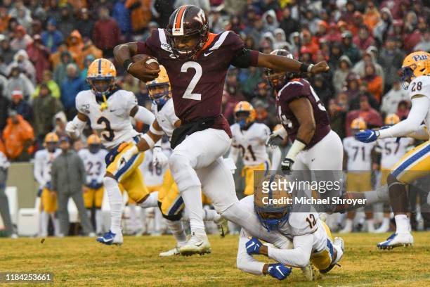 Quarterback Hendon Hooker of the Virginia Tech Hokies evades the tackle of defensive back Paris Ford of the Pittsburgh Panthers in the first half at...