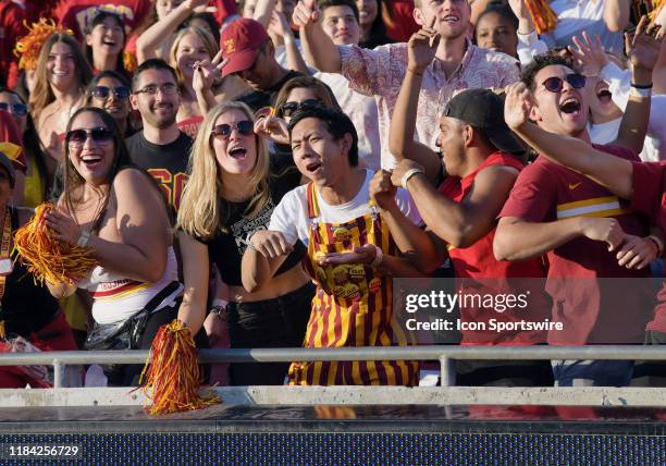 Trojans fans celebrate in the USC student section during the fourth quarter of a college football game against the UCLA Bruins played on November 23,...