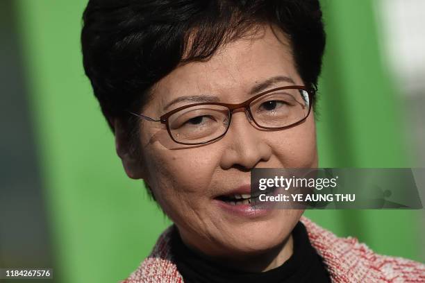Hong Kong Chief Executive Carrie Lam speaks to the press after casting her vote during the district council elections in Hong Kong on November 24,...