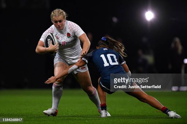 Abi Burton of England is tackled by Kayla Canett of USA during the Rugby X Final at The O2 Arena on October 29, 2019 in London, England.