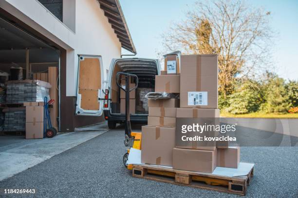 packages on a forklift in front of the delivery van - moving truck stock pictures, royalty-free photos & images