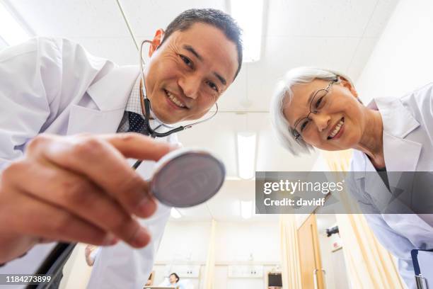 pov image of a patient being examined by doctors - personal perspective doctor stock pictures, royalty-free photos & images