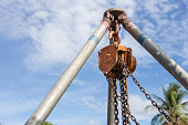 Chain hoist used in construction on blue sky background