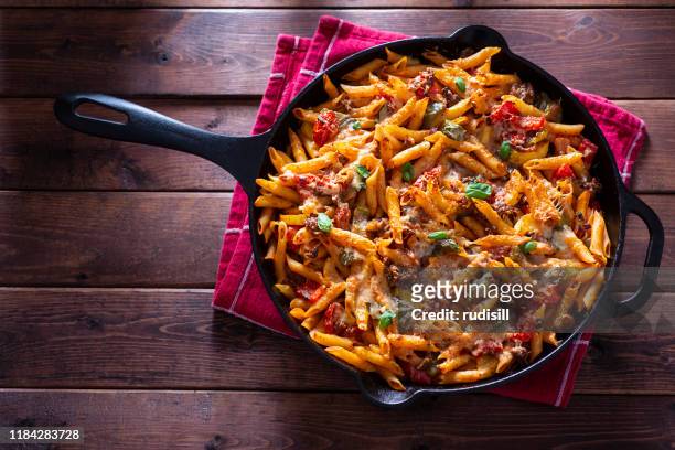 baked pasta skillet - sausage stock pictures, royalty-free photos & images