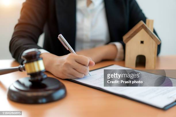 woman auction or scene of lawyers or notaries with gavel judge for house insurance compensations. concept of law and lawyer, judiciary and legislature applied to the democratic law. - house auction stockfoto's en -beelden