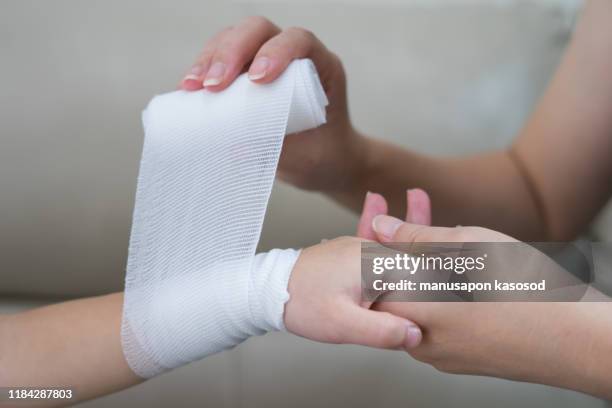 child hand with gauze bandage on it. - gauze stock pictures, royalty-free photos & images