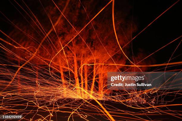 High winds blow hot embers from the Kincade Fire on October 29, 2019 in Calistoga, California. Fueled by high winds, the Kincade Fire has burned over...