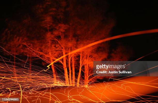 Embers fly as high winds blow hot spots from the Kincade Fire on October 29, 2019 in Calistoga, California. Fueled by high winds, the Kincade Fire...