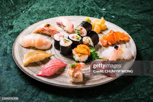 japanese sushi nicely presented in plate - sushi plate stock pictures, royalty-free photos & images