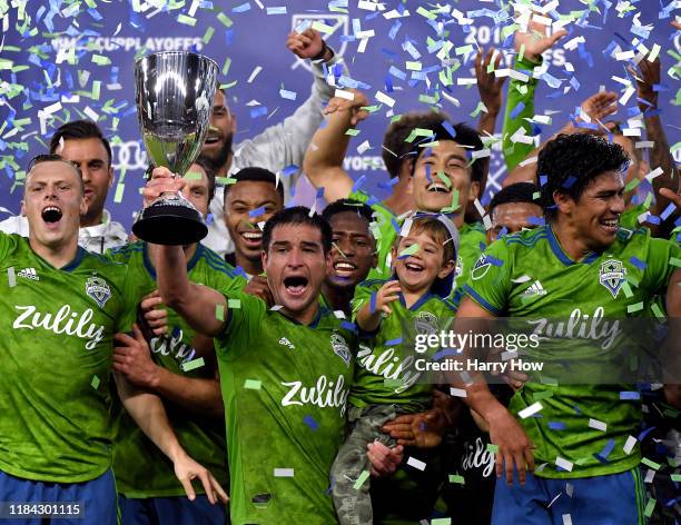 Nicolas Lodeiro of Seattle Sounders hold up the trophy in celebration of a 3-1 win over the Los Angeles FC during the Western Conference finals at...
