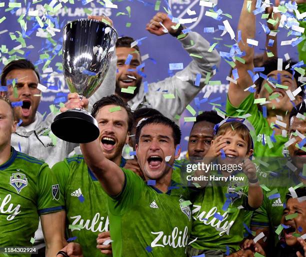 Nicolas Lodeiro of Seattle Sounders hold up the trophy in celebration of a 3-1 win over the Los Angeles FC during the Western Conference finals at...