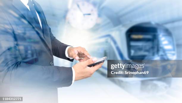 business people using smartphones while waiting for the subway or skytrain - scoring system stock pictures, royalty-free photos & images