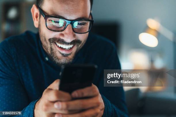 texting - man laughing smiling stock pictures, royalty-free photos & images