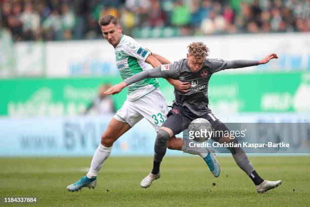 Robin Hack of 1.FC Nürnberg challenges Paul Seguin of SpVgg Greuther Fürth during the Second Bundesliga match between SpVgg Greuther Fürth and 1. FC...
