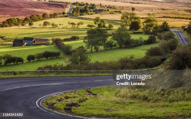 beautiful empty country road in a rural landscape in the north of england - empty road stock pictures, royalty-free photos & images