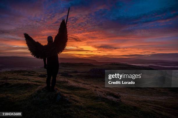black winged warrior angel at dawn - human with wings silhouette man stock pictures, royalty-free photos & images