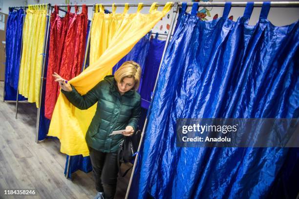 Woman exists a voting booth during the second round of Romanian presidential elections, in Bucharest, Romania, on November 24, 2019.
