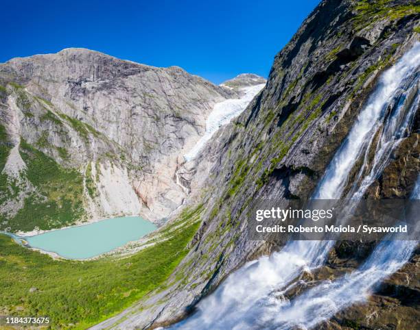 waterfall above briksdalsbreen glacier, loen, norway - glaciar de briksdalsbreen fotografías e imágenes de stock
