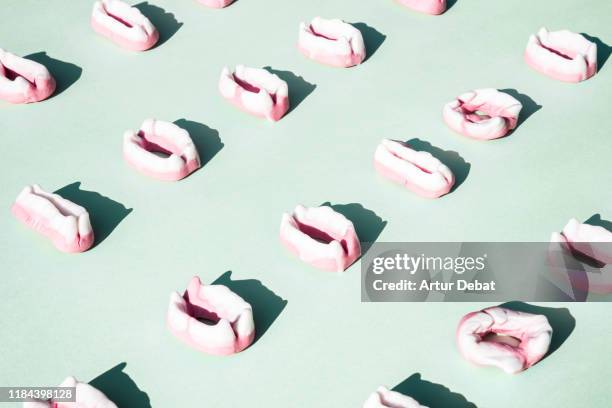 multiple vampire candy teeth arranged in a row. - candy lips stock pictures, royalty-free photos & images