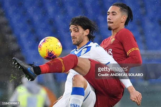 Brescia's Italian forward Ernesto Torregrossa and Roma's English defender Chris Smalling go for the ball during the Italian Serie A football match...