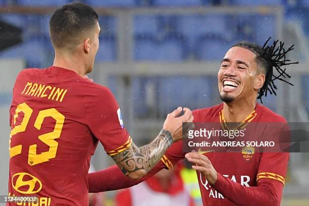 Roma's Italian defender Gianluca Mancini celebrates with AS Roma's English defender Chris Smalling after scoring his team's second goal during the...