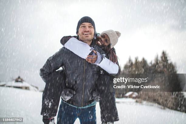 enjoying their winter vacation - black snow stock pictures, royalty-free photos & images