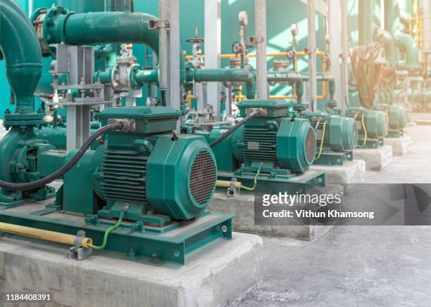 pump and steel pipelines at factory - centrifugal force stockfoto's en -beelden