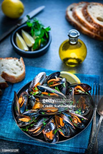 steamed mussels on blue background - mussels stock pictures, royalty-free photos & images