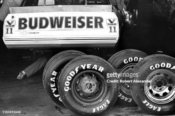 Crew members for NASCAR driver Darrell Waltrip work on their racecar in the speedway garage area prior to qualifying for the 1985 Daytona 500 stock...