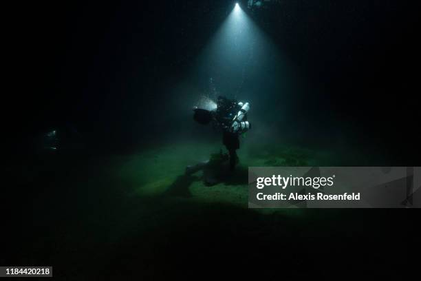 At 111m depth, biologist diver Gilles Siu is taking water samples in a "Niskins" bottle for environmental DNA analysis on September 25, 2019 off the...