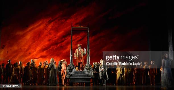 Andreas Bauer Kanabas as Sarastro and Elsa Dreisig as Pamina with artists of the company in The Royal Opera's Production of Wolfgang Amadeus Mozart's...