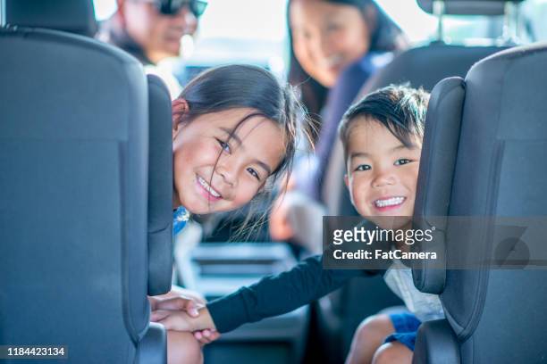 foto de stock de mixed race family of four road trip - kids inside car fotografías e imágenes de stock
