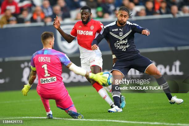 Bordeaux's French goalkeeper Benoit Costil makes a save in front of Monaco's French midfielder Tiemoue Bakayoko during the French L1 football match...