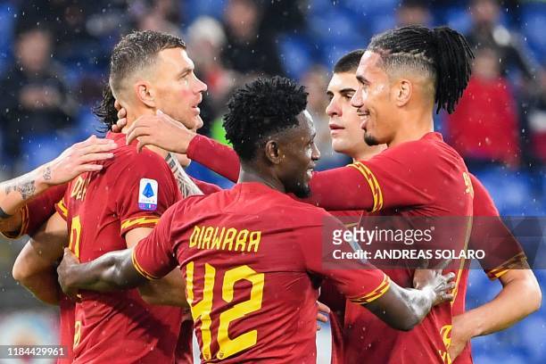 Roma's Bosnian forward Edin Dzeko celebrates with teammates after scoring during the Italian Serie A football match Roma vs Brescia on November 24,...