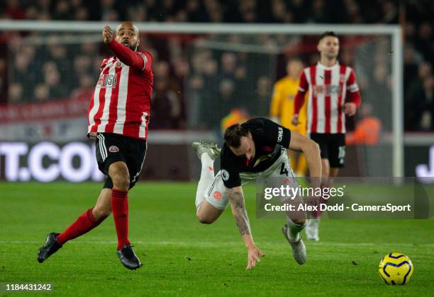 Sheffield United's David McGoldrick tangles with Manchester United's Phil Jones during the Premier League match between Sheffield United and...