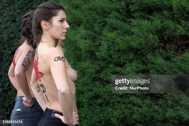 This image contains nudity.) FEMEN activist with body paint reading 'To fascism neither honor nor glory' during a rally commemorating the 44th...