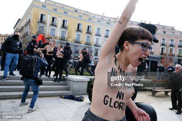 This image contains nudity.) FEMEN activist with body paint reading 'To fascism neither honor nor glory' during a rally commemorating the 44th...