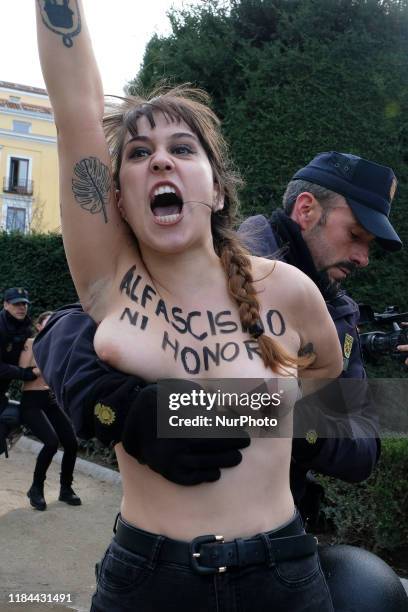 This image contains nudity.) FEMEN activist with body paint reading 'To fascism neither honor nor glory' during a rally commemorating the 44th...