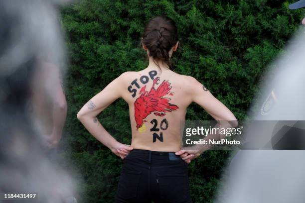 This image contains nudity.) FEMEN activist with body paint reading 'To fascism neither honor nor glory' during a rally commemorating the 44th...