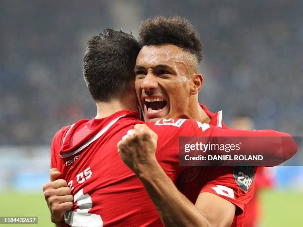 Mainz' German midfielder Levin Oztunali celebrate scoring the opening goal with his teammate Mainz' Austrian forward Karim Onisiwo during the German...