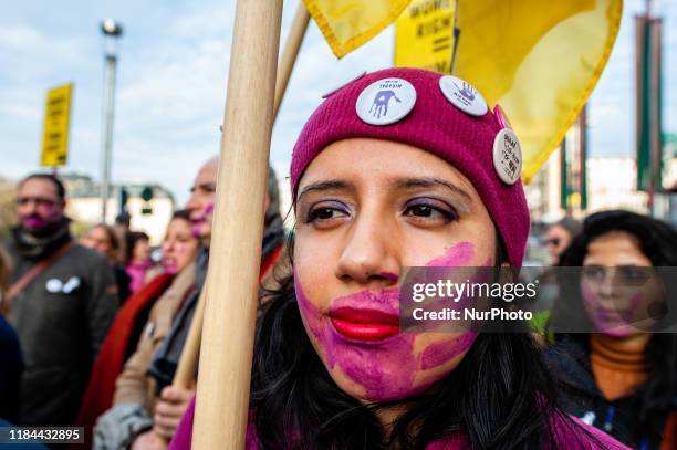 Woman has a violet hand painted in her face, during the demonstration stop violence against women, in Brussels on November 24th, 2019.