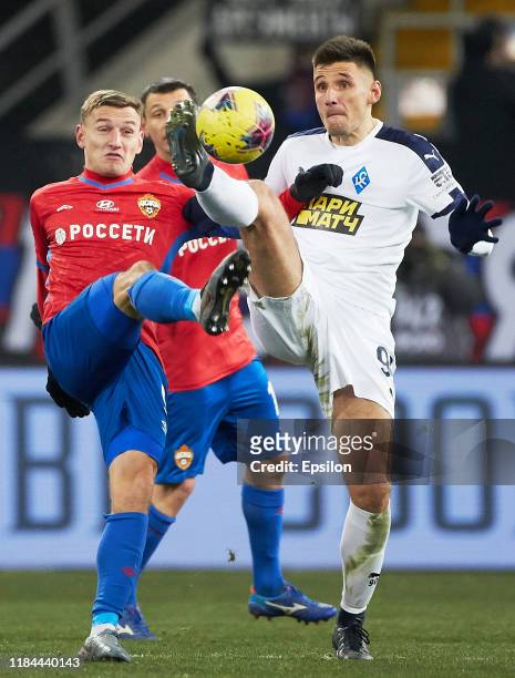 Fyodor Chalov of PFC CSKA Moscow and Taras Burlak of FC Krylia Sovetov Samara vie for the ball during the Russian Football League match between PFC...