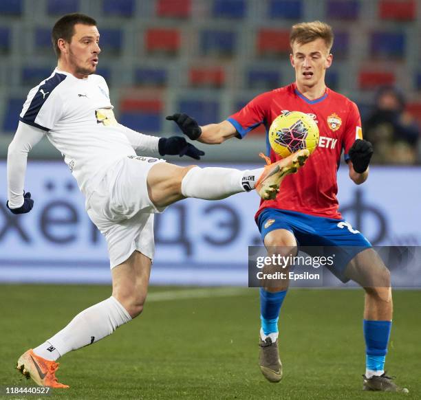 Konstantin Kuchayev of PFC CSKA Moscow and Dejan Radonjic of FC Krylia Sovetov Samara vie for the ball during the Russian Football League match...