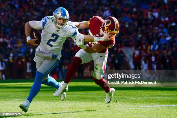 Jeff Driskel of the Detroit Lions stiff-arms Cole Holcomb of the Washington Redskins in the first half at FedExField on November 24, 2019 in...