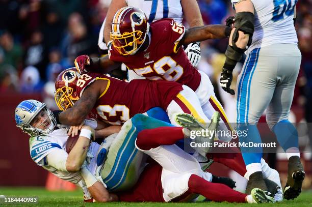 Jeff Driskel of the Detroit Lions is sacked by Jonathan Allen and Ryan Kerrigan of the Washington Redskins in the second quarter at FedExField on...