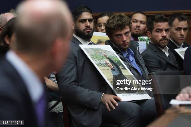 Family members of those who died aboard Ethiopian Airlines Flight 302 look on as Dennis Muilenburg, president and CEO of the Boeing Company,...