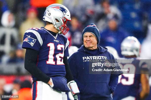 Tom Brady talks to head coach Bill Belichick of the New England Patriots before a game against the Dallas Cowboys at Gillette Stadium on November 24,...