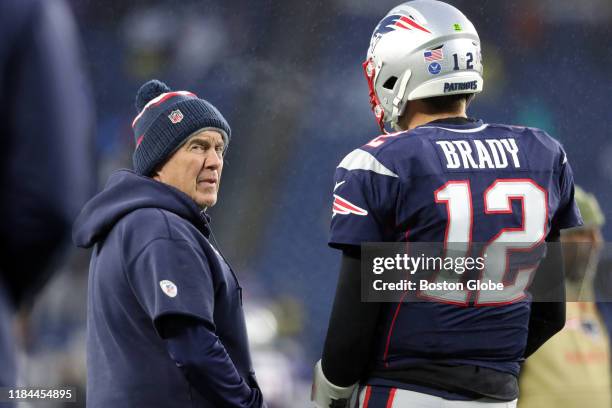 New England Patriots head coach Bill Belichick and quarterback Tom Brady talk on the field before the game. The New England Patriots host the Dallas...