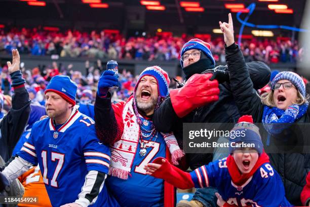 Buffalo Bills fans celebrate a review resulting in a touchdown for the Buffalo Bills during the fourth quarter against the Denver Broncos at New Era...