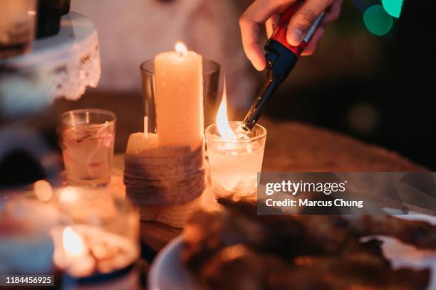 asian chinese doing preparation and light up the candle before christmas party begin at roof top of house - cigarette lighter stock pictures, royalty-free photos & images